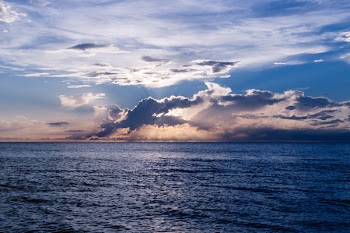 Wide Angle Photo of Body of Water Under Cloudy Sky