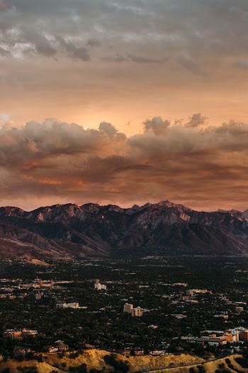 wide angle photo of mountain under cloudy sky