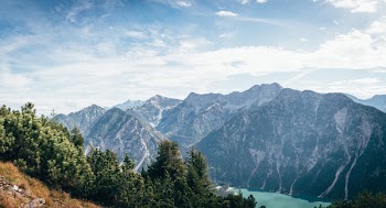 Wide Angle Photo of Mountains Under Cloudy Sky