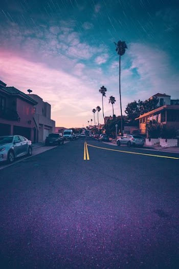 wide angle photo of road under cloudy sky