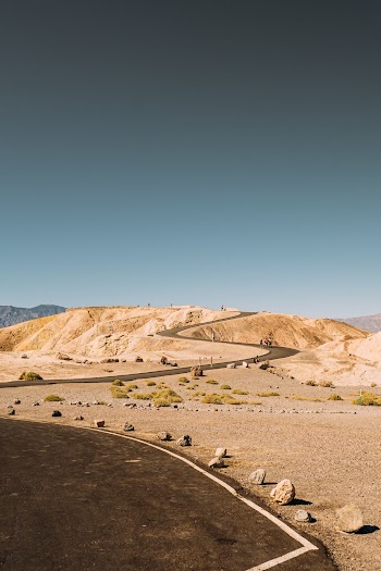 Wide Winding Road In The Desert Under Blue Sky
