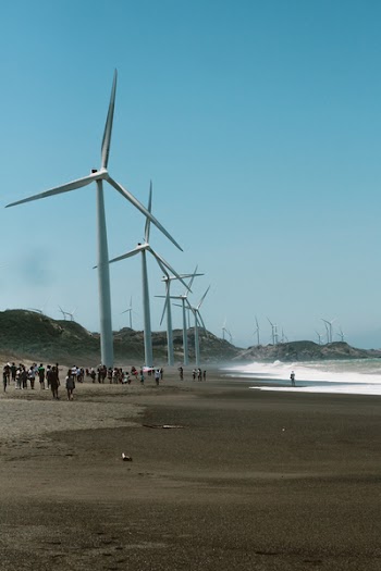 Wind Mills Near the Body of Water