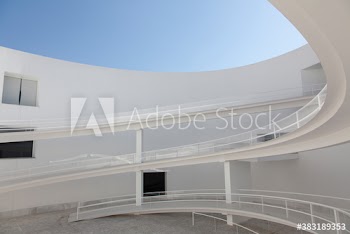 Winding ramps in modern building courtyard