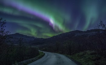 Winding Road Leading to the Mountains Under a Sky Phenomenon