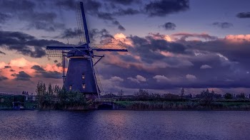 Windmill Near River during Sunset