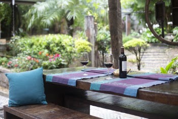 Wine Bottle and Glasses on Purple Mat