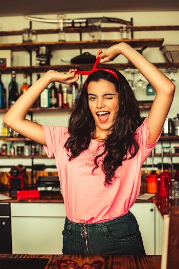 Winking Woman Holding Her Hairband