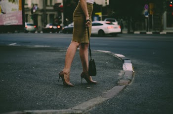 Woman's Holding Black Sling Bag