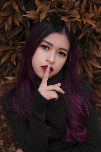 Woman's Index Finger on Her Lips
