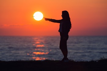 Woman Across Sun during Dawn