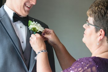Woman Affixing Flower on Suit Jacket