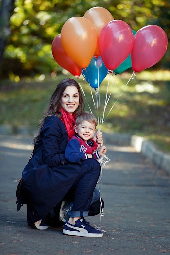 Woman and Boy Holding Balloons
