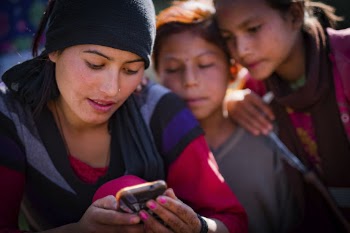Woman and children looking at phone, | Free Photo - rawpixel