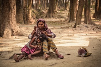 Woman and Girl Sitting on Ground
