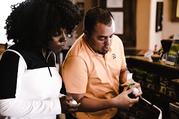 Woman and Man Looking at Golf Balls
