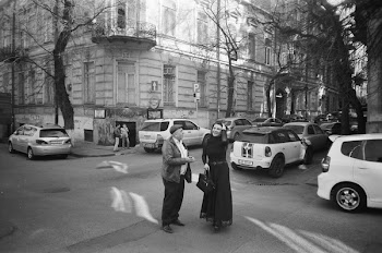 Woman and Man on Gray Concrete Pavement Road in Grayscale Photo