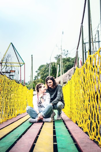 Woman and Man Sitting on Bridge