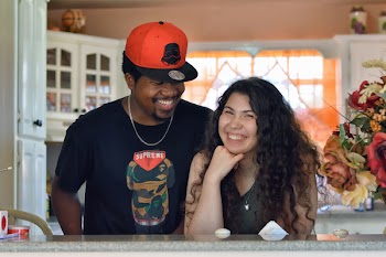 Woman and Man Standing In-front of Gray Table