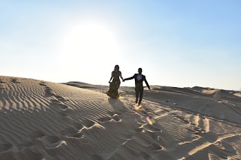 Woman and Man Standing on the Desert