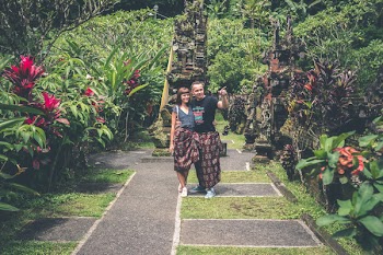 Woman and Man Standing Together and Looking on Flower Garden
