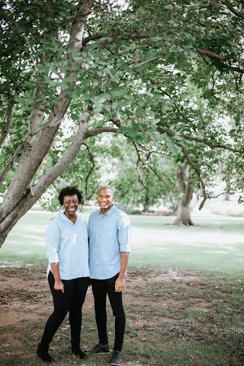 Woman and Man Standing Under Tree Branch