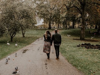 Woman and Man Walking on Road