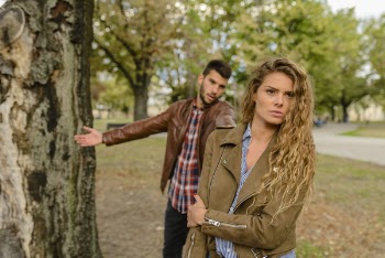Woman And Man Wearing Brown Jackets Standing Near Tree