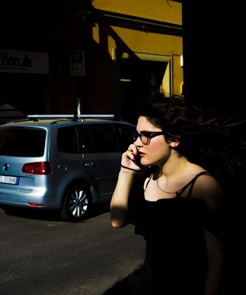 Woman Answering Phone Near Parked Vehicle