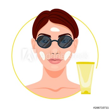 Woman applying sun protection on the face skin