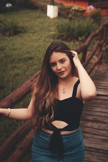 Woman at Foot Bridge While Holding Her Hair