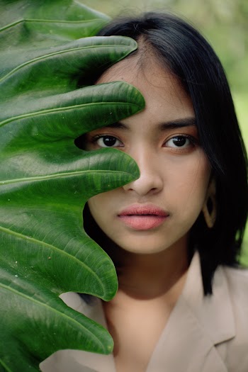 Woman Behind Big Leaf