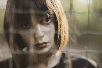 Woman Behind Fence