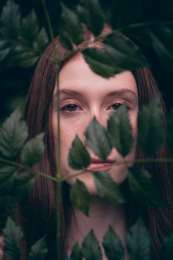 Woman Behind Green Leaves