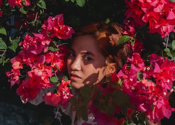 Woman Behind Pink Flowers