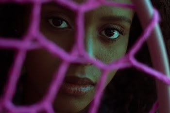 Woman Behind Pink Net