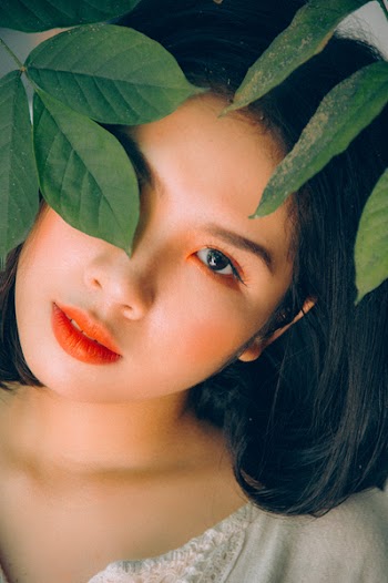 Woman Behind the Green Leaf