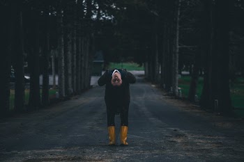 Woman Bending in Middle of Road
