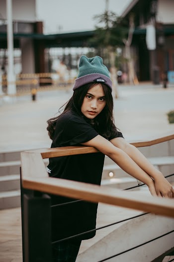 Woman Beside Brown Wooden Railing