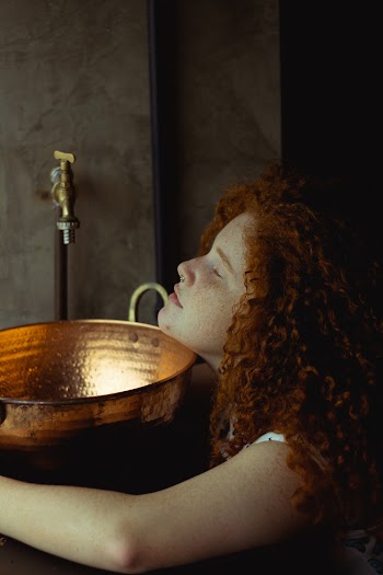 Woman Beside Faucet