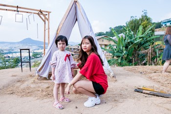 Woman Beside Gift in Front of Tent