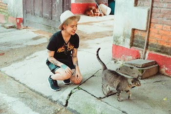 Woman Beside Gray Tabby Cat