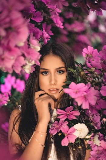 Woman Beside Pink-petaled Flowers