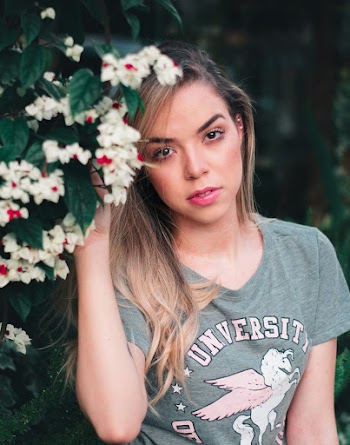 Woman Beside Plants With White Petaled Flowers