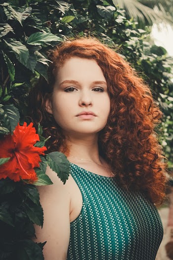 Woman Beside Red Flower