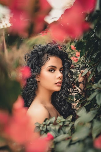 Woman Beside Red Flowers