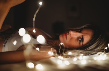 Woman Beside String Lights