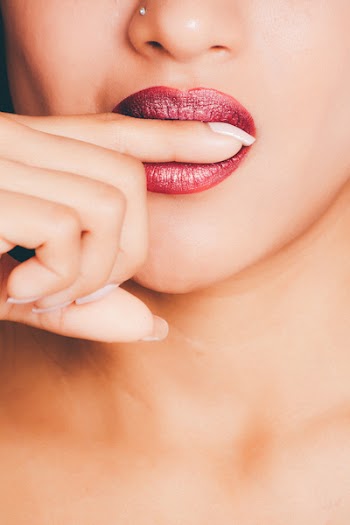 Woman Biting Index Finger