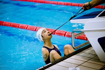 Woman Biting Rubber to Get Out of Pool
