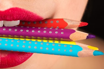 Woman Biting Three Color Pencils