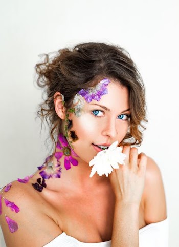 woman biting white flower